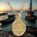 ships in the background showing the charm: Burn the Boats Motivational Charm Pendant Jewelry in Gold by Lat & Lo- Wax seal-Coin shaped jewelry-gift jewelry-inspiring necklace charm