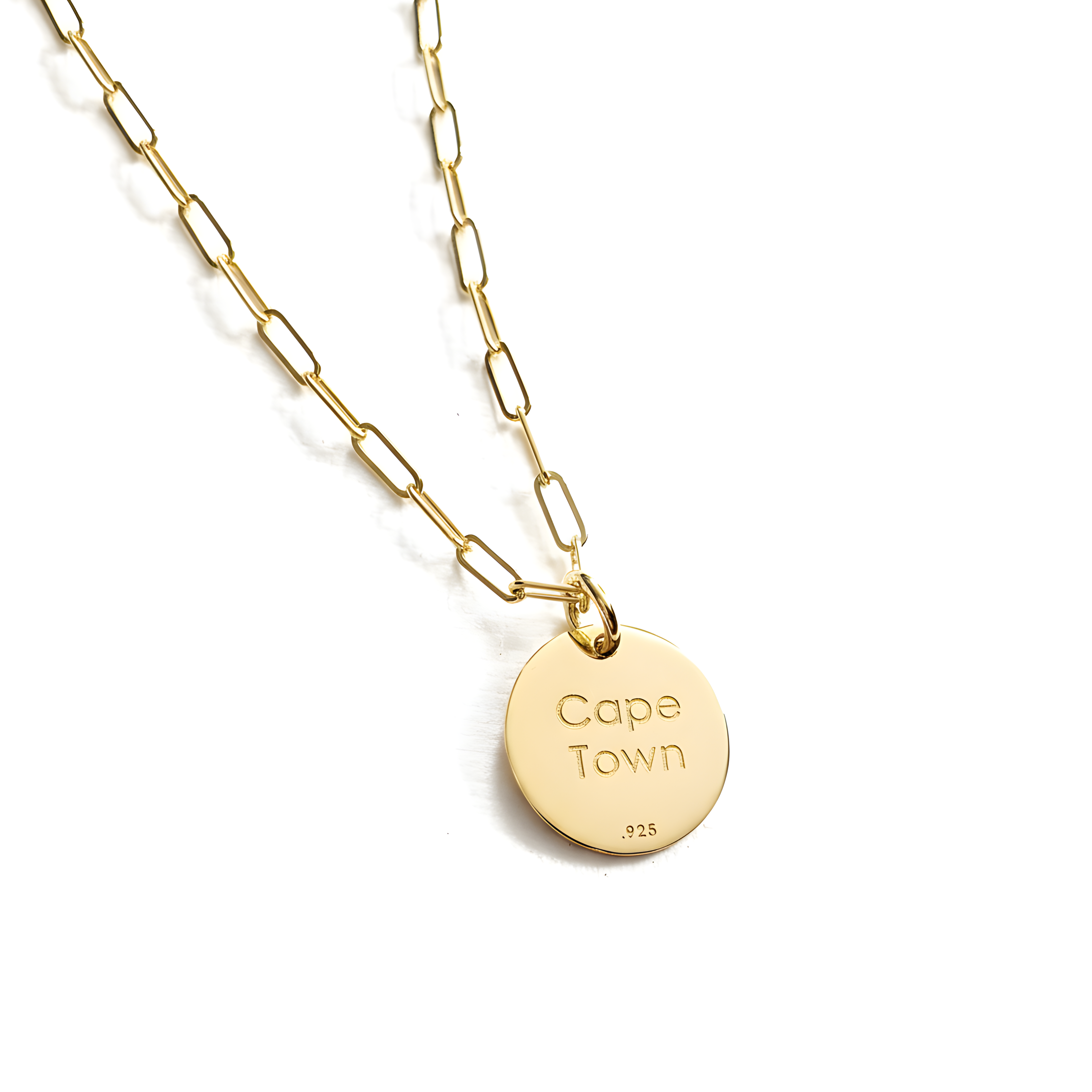 a round gold pendant necklace with paperclip chain. The back of the disc pendant is engraved with Cape Town. Persanlized jewelry by Lat & Lo