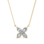Diamond flower pendant on a gold chain against a white background