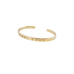 Gold bracelet with engraved coordinates on a white background