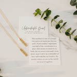 Friendship Necklace with a card on a marble surface with eucalyptus  leaves by Lat & Lo