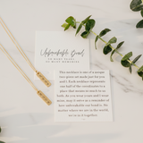 Friendship Necklace with a card on a marble surface with eucalyptus  leaves by Lat & Lo