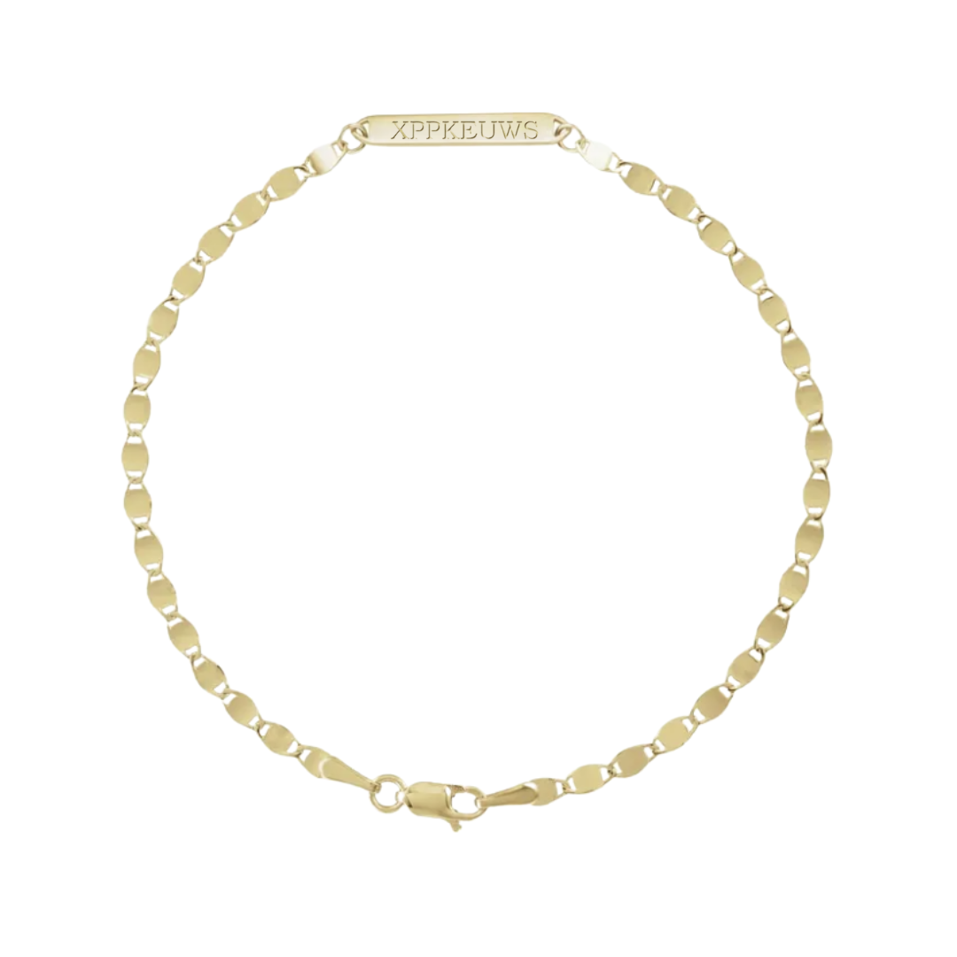 A gold chain bracelet with a lobster clasp and a rectangular tag engraved with 'XPPKEUWIS' in gold lettering, displayed on a clean white background.