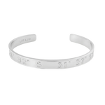 Silver bracelet with engraved coordinates on a white background