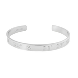 Silver bracelet with engraved coordinates on a white background