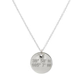 Lat & Lo disc necklace in sterling silver inscribed with custom coordinates.