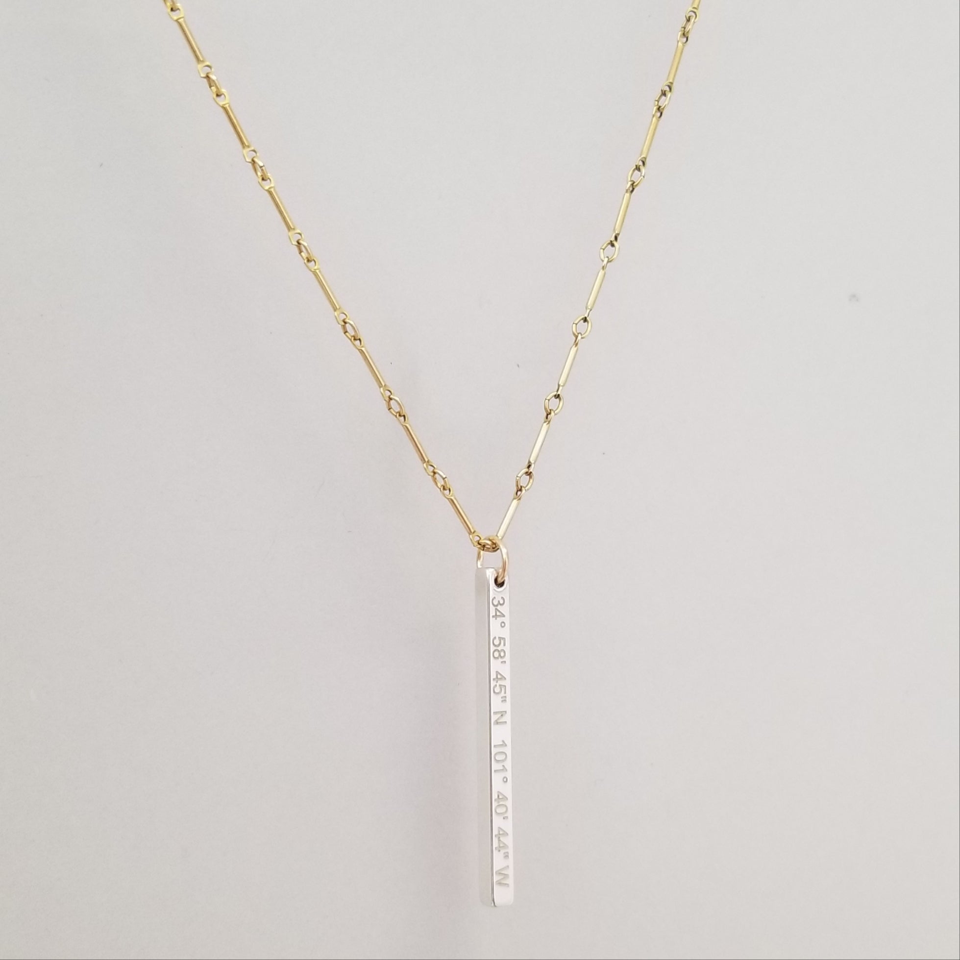 Lat & Lo Bicoastal necklace, sterling silver vertical column pendant on yellow gold filled bar and link chain, inscribed with coordinates
