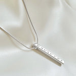 Sterling Silver coordinates necklace on satin. Column pendant. By Lat & Lo.