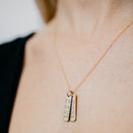 Lat & Lo coordinates charm necklace in gold with two charms on model
